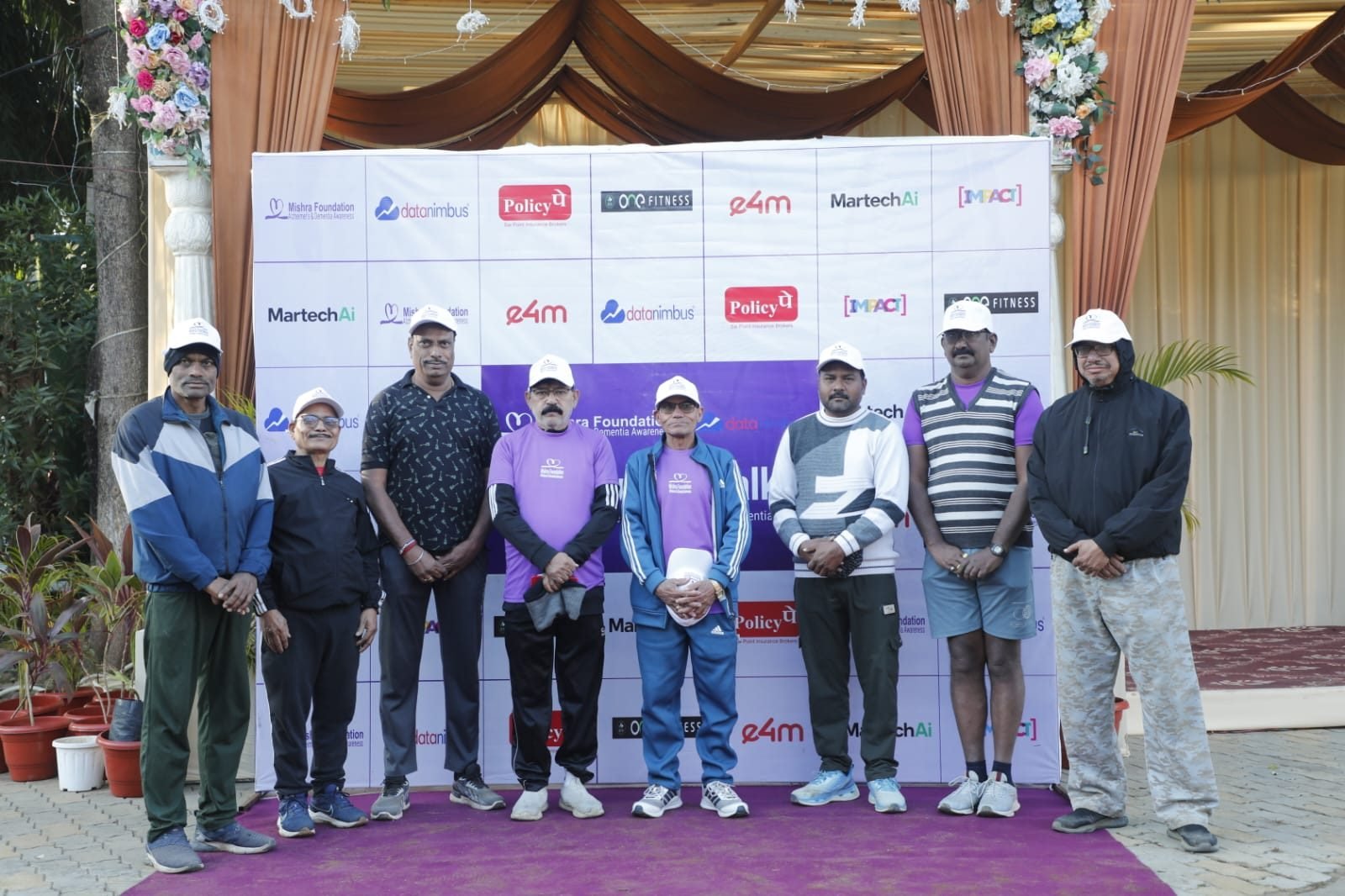Participants at the start line of The Purple Walk, including children and elders